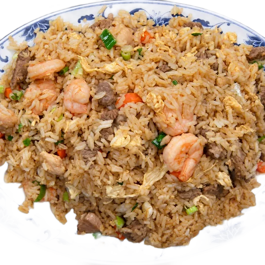 Fried rice with shrimp, beef and chicken on a blue and white platter