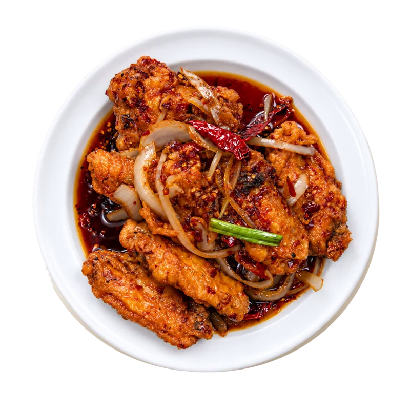 Hot braised chicken wings with onions on a white plate